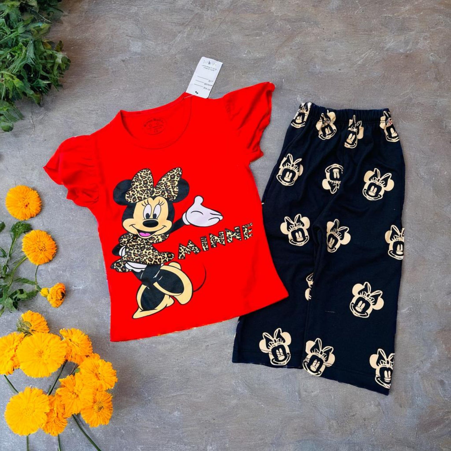 Adorable Minnie Mouse outfit for toddlers featuring a red top and black pants with a cute pattern